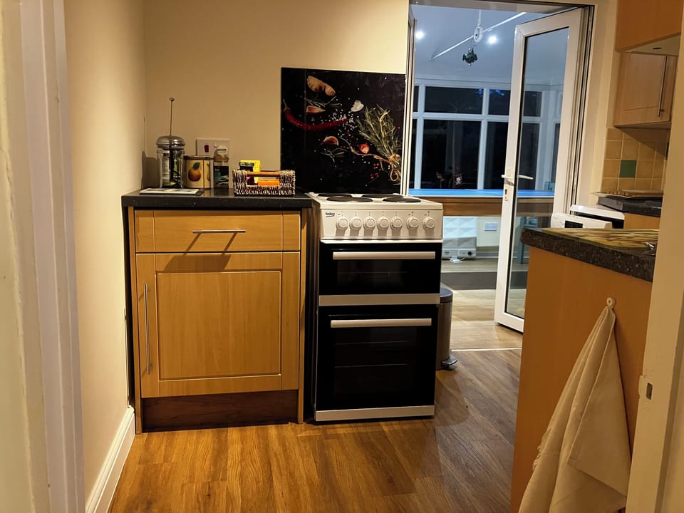 Kitchen with adjoining garden room/ dining table.