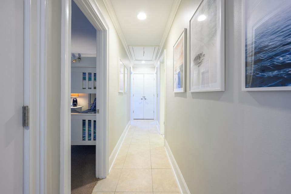 Hallway to twin BR on left and Queen BR further down on the right