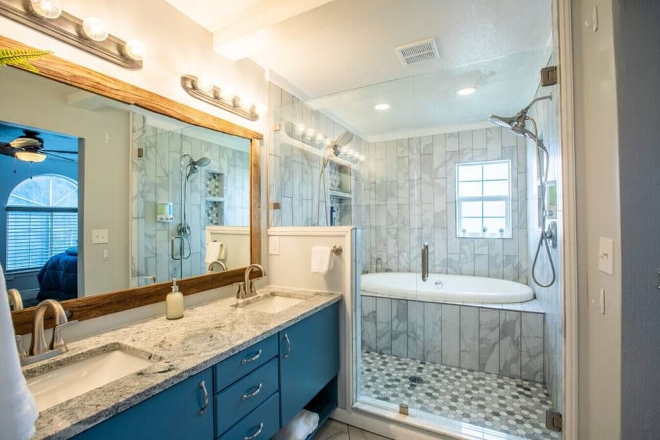 Modern bathroom with tub and spacious vanity.