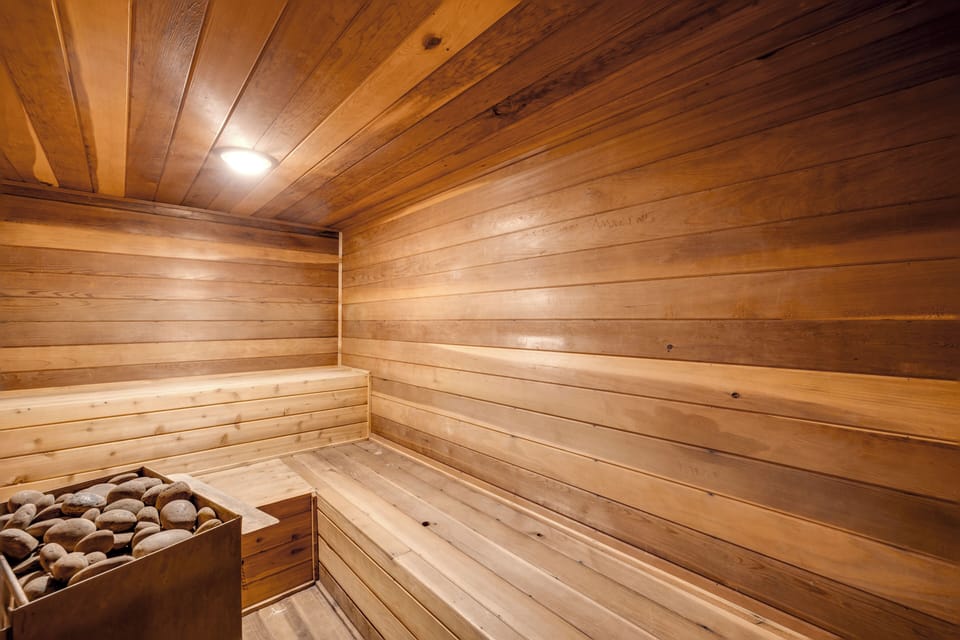 Step into a sauna where warm cedar surrounds you. Hot stones create the perfect atmosphere for deep relaxation.