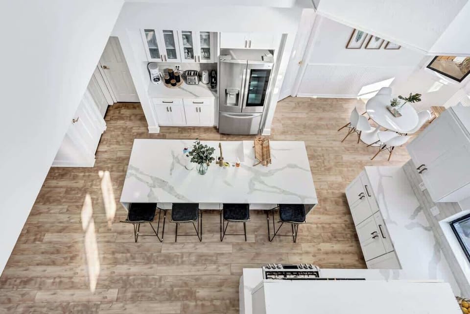 A spacious, fully equipped kitchen with a large island and seating—perfect for cooking, gathering, and enjoying meals together.