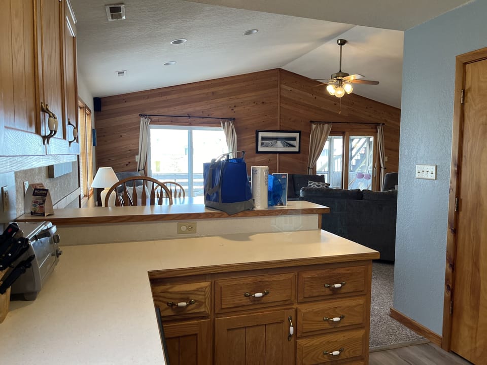 Kitchen view - Well-appointed kitchen featuring granite countertops, white and stainless-steel appliances, and a breakfast bar, ideal for preparing home-cooked meals.