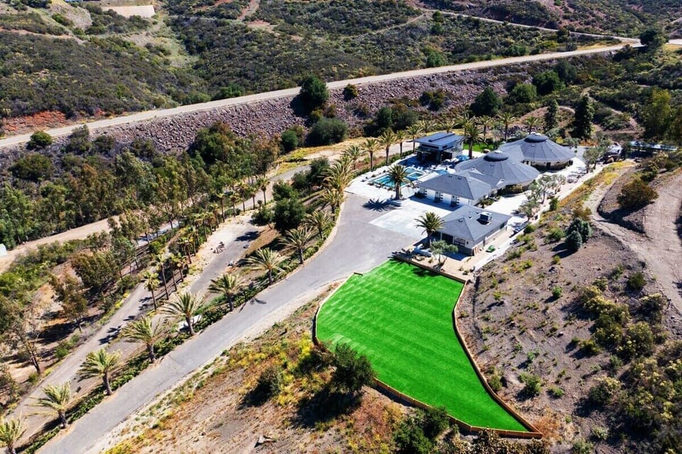 A resort-style layout with lush turf, palms, and grand estate design!