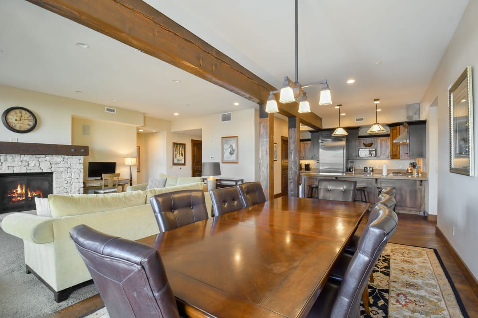 Gather around the spacious dining table with seating for eight, seamlessly connected to the inviting living room and kitchen.