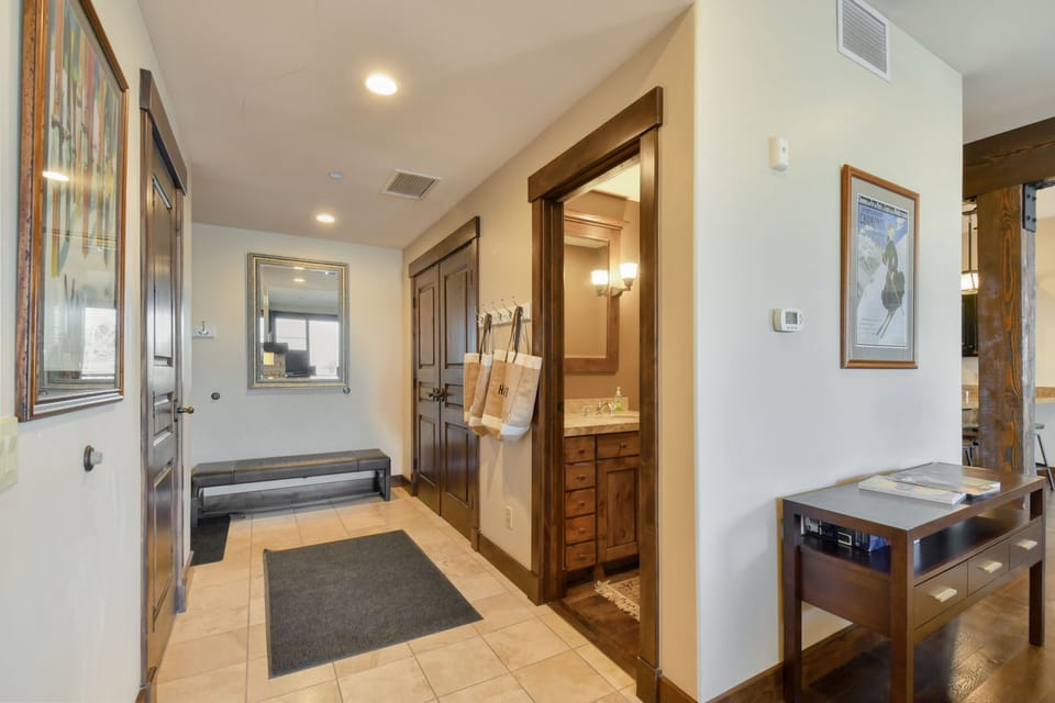 Entryway into apartment with powder room and closet space.