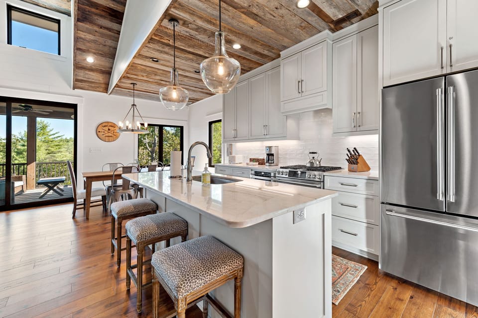 A modern kitchen equipped with stainless steel appliances, quartz countertops ideal for preparing meals.
