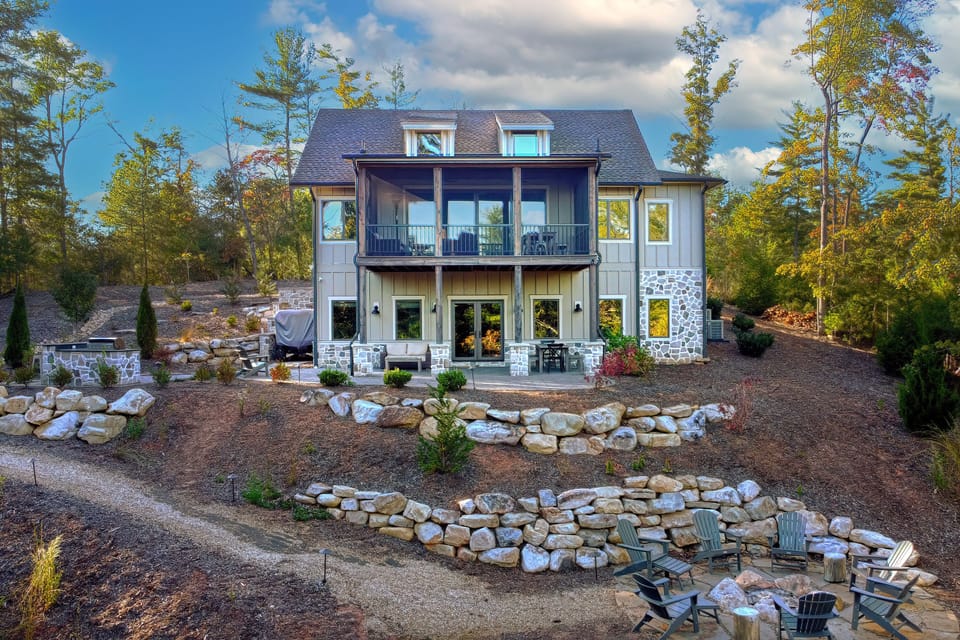 A stunning exterior shot showcasing the lodge's modern architecture, nestled atop a hill with panoramic views of Lake James.