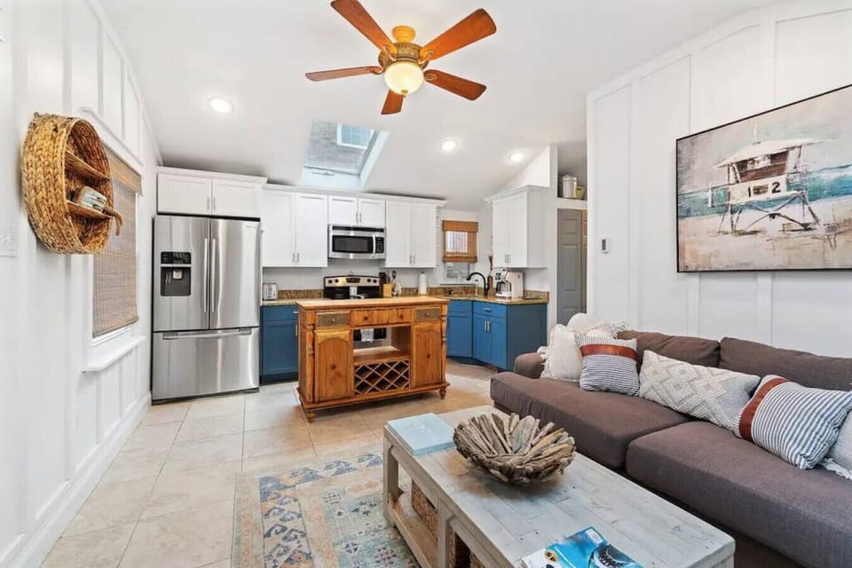 This updated cottage offers a cozy living area, fully equipped kitchen, and is just a short walk from the beach
