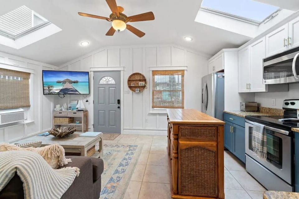 This updated cottage features a cozy living area, full kitchen, and is just steps from the beach.