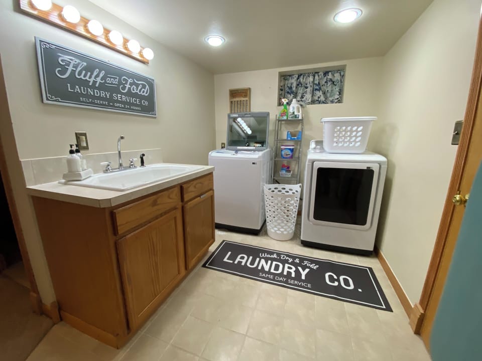 Laundry room with new large washer and dryers.