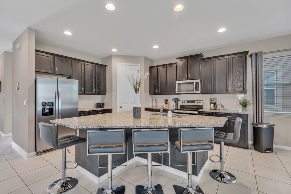 Well stocked, beautiful kitchen, with five island stools.