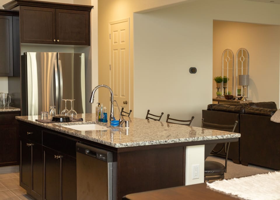 The fully equipped kitchen with granite countertops is ready for your cooking!