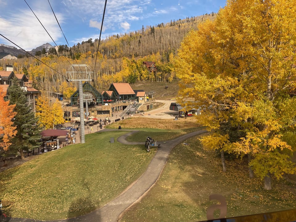 Autumn view as gondola approaches mountain village core