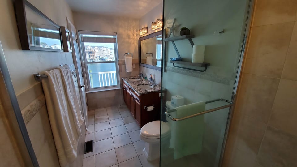 Master bathroom with view of Snug Harbor. Each bathroom has blow dryer.