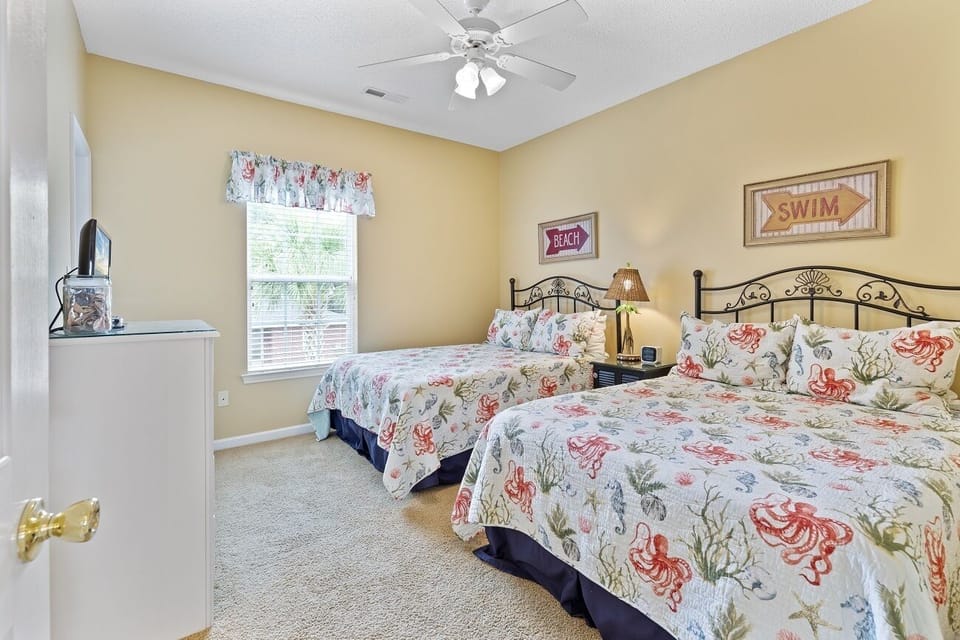 Downstairs bedroom with 2 double beds and attached bathroom.