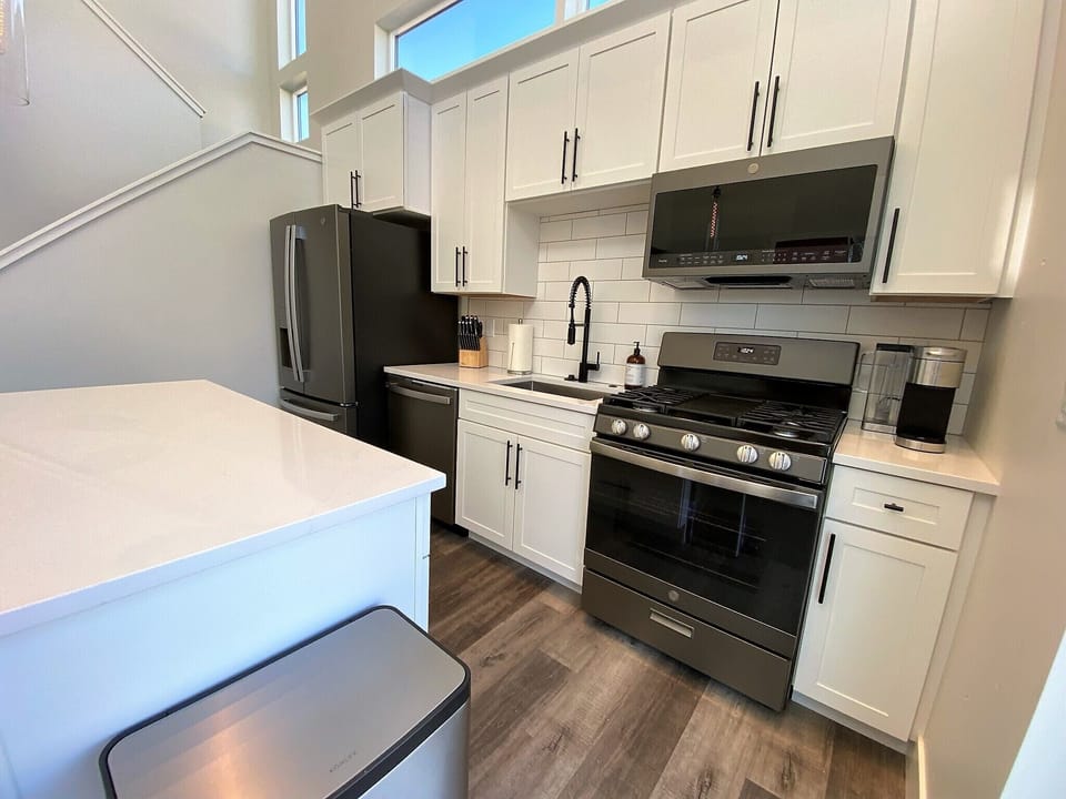 Full sized stainless steel appliances including a gas stove