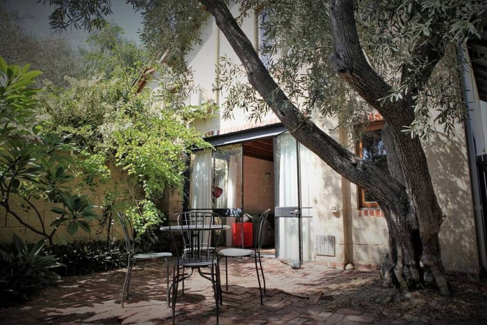 Fully fenced and private courtyard with large trees and BBQ