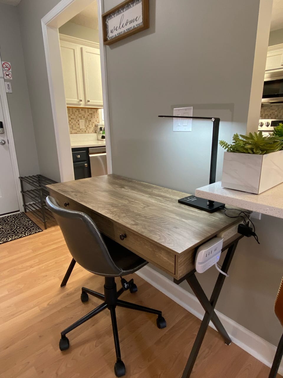 Office desk with ergonomic chair, outlet & USB plug ins, desk lamp. 