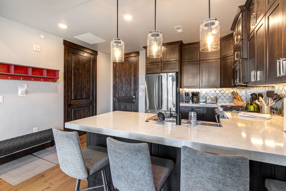 Condo Entry and Fully Equipped Kitchen with bar seating for four