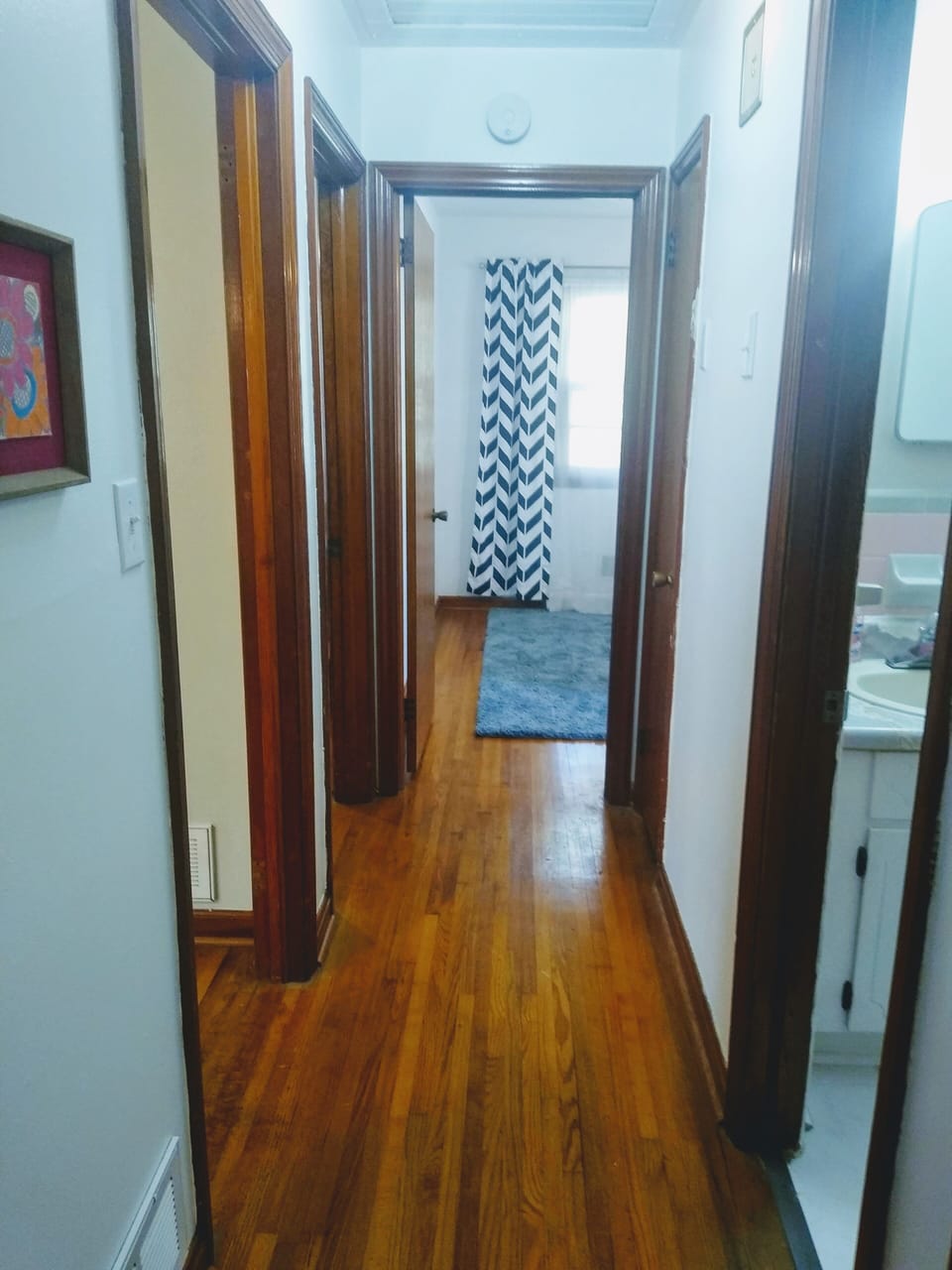 Hallway leading to 3 bedrooms & Full Bath. Lovingly restored HW floors 