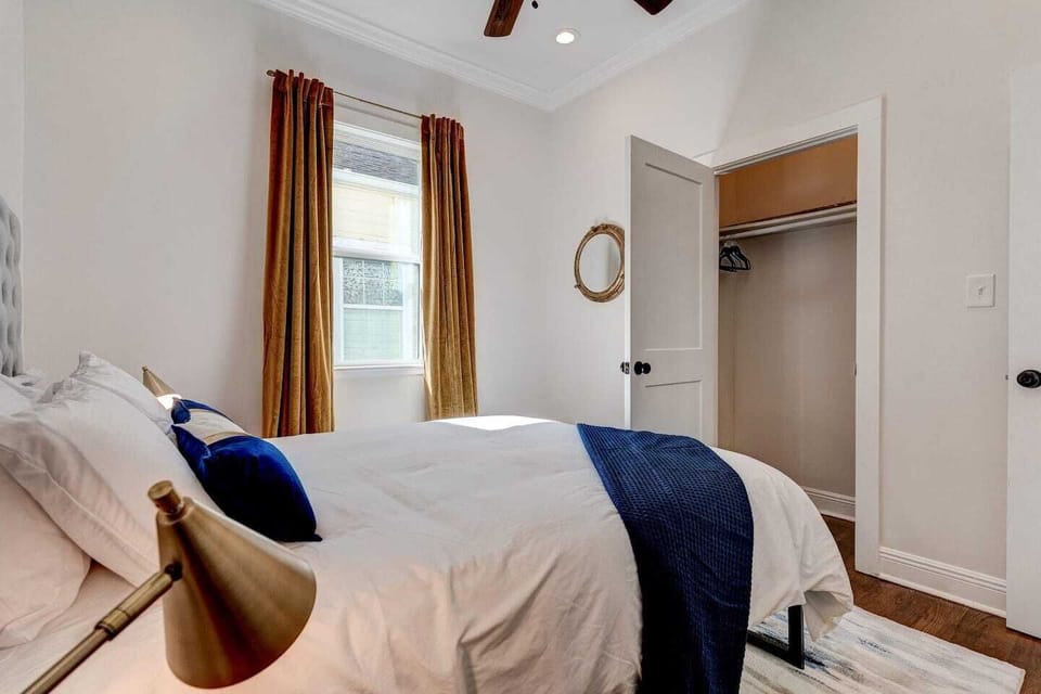 Sunlit bedroom corner w/ navy accents & a warm, inviting atmosphere.