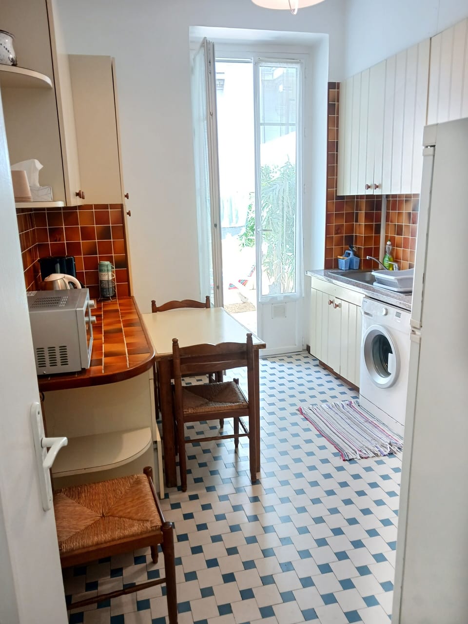 The kitchen is bright and leads directly out to the terrace