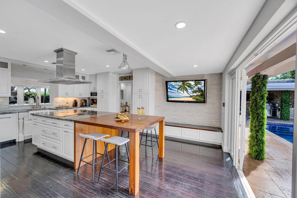 The Chef's Kitchen with its own seating for casual meals and access to the heated pool.