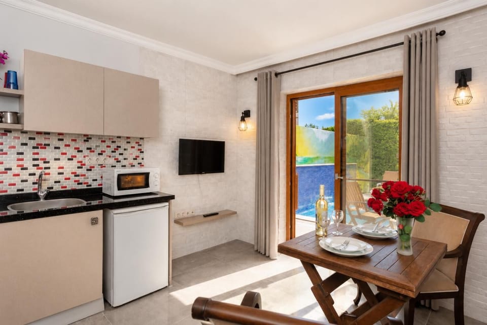Open-plan living room with dining area, kitchen, A/C, WiFi internet, satellite TV, and pool terrace access