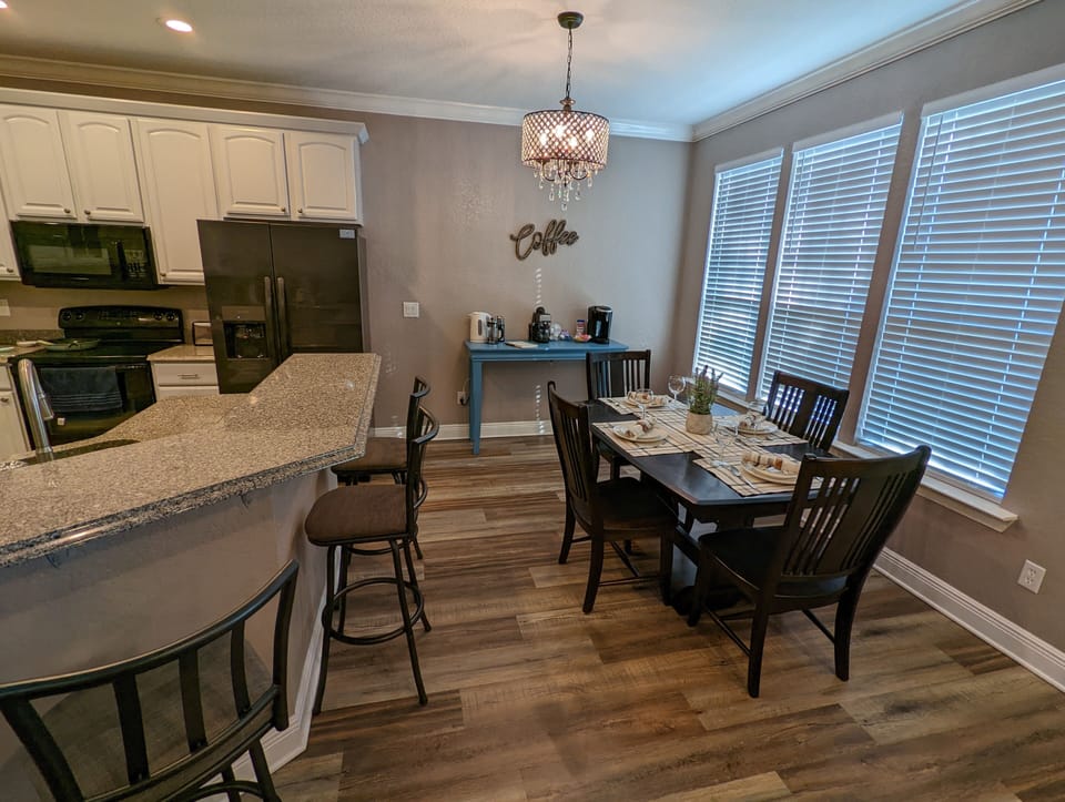Bar seating and dining table close to breakfast coffee bar