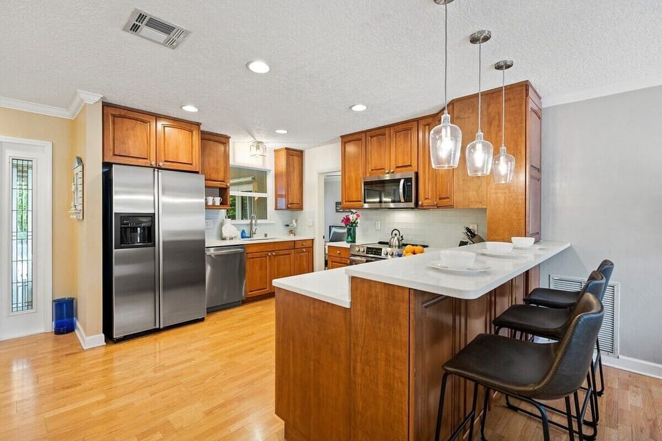 Prepare a family meal in the fully-equipped custom kitchen offering bar seating  and updated appliances.