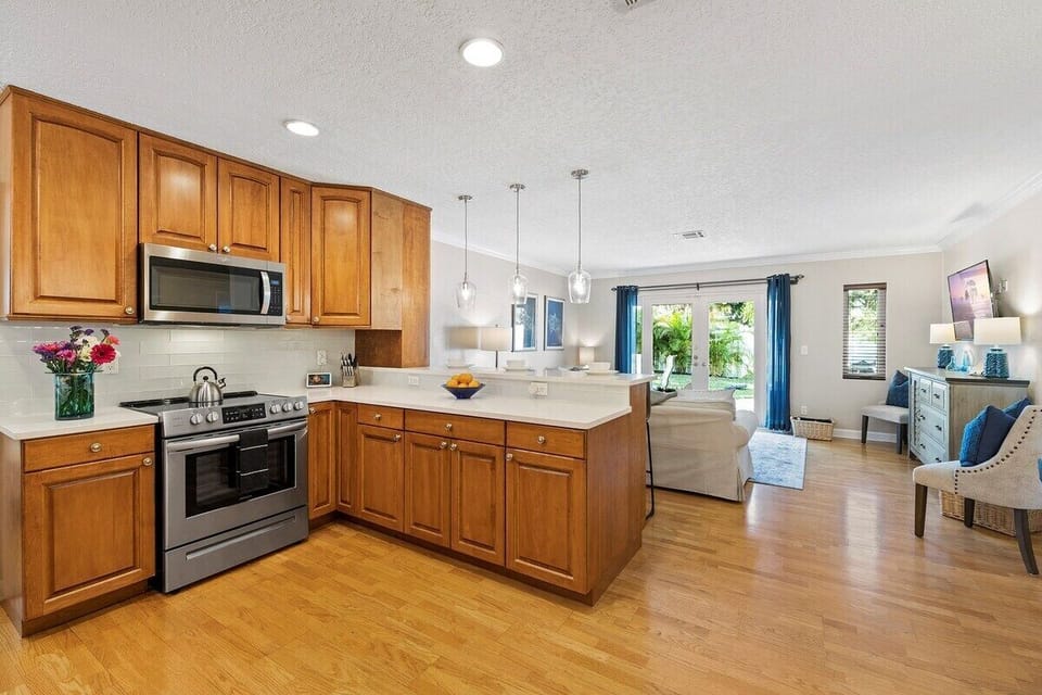 Prepare a family meal in the fully-equipped custom kitchen offering bar seating  and updated appliances.