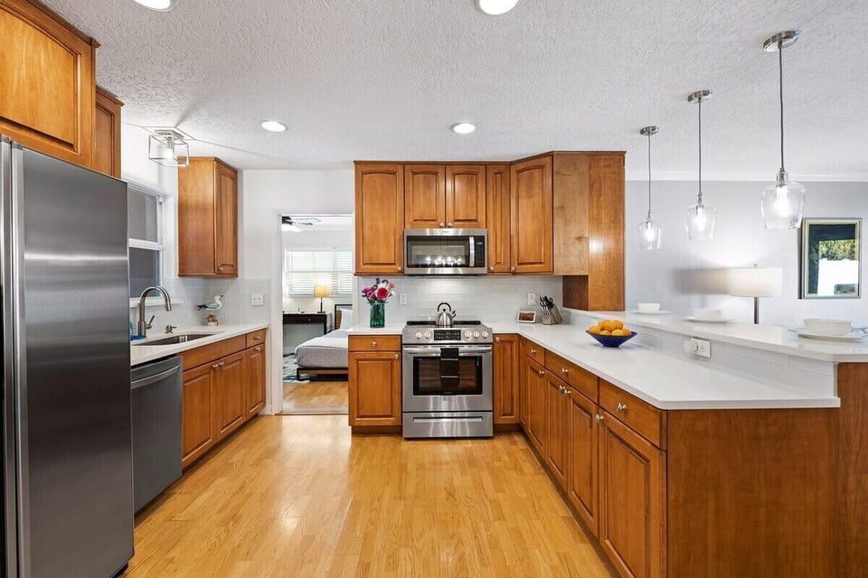 Prepare a family meal in the fully-equipped custom kitchen offering bar seating  and updated appliances.