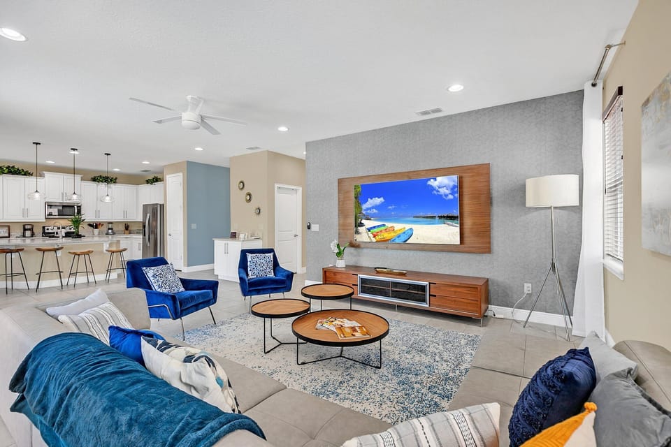 Enjoy your morning coffee with views of the lush backyard and pool through panoramic glass doors.