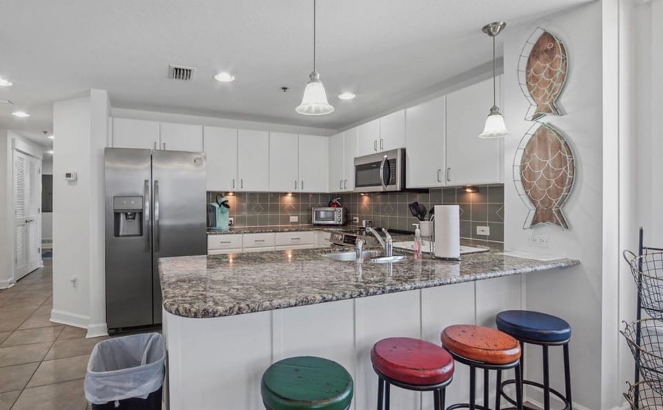 Your spacious kitchen features granite counters, stainless appliances, and cheerful bar seating where you'll love sharing morning coffee and evening meals.