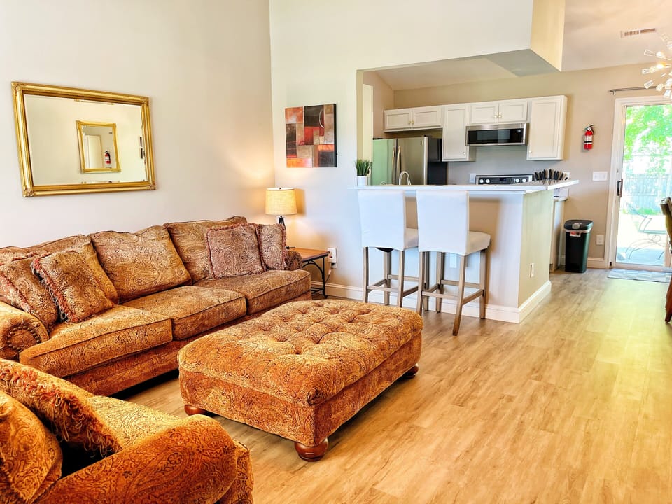 spacious living room that opens into dining room and kitchen