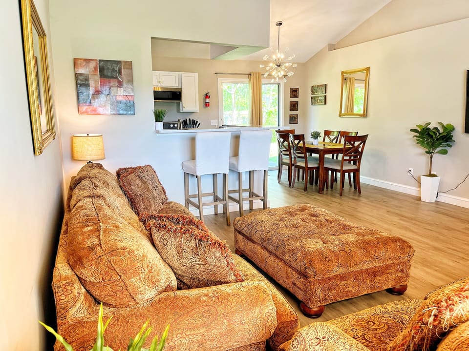 spacious living room that opens into dining room and kitchen