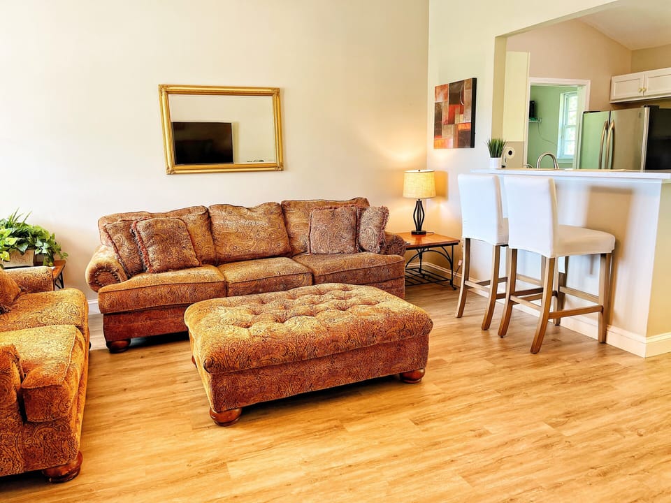 spacious living room that opens into dining room and kitchen