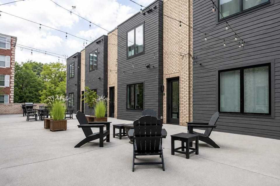Modern shared courtyard with cozy seating areas, string lights, and stylish outdoor spaces perfect for relaxing and gathering with friends or family.
