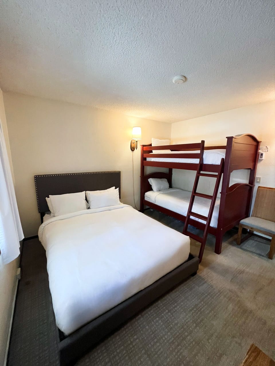 Bedroom 2 has a queen sized bed and single over single bunk beds. Bedroom 2 has TV and closet.
