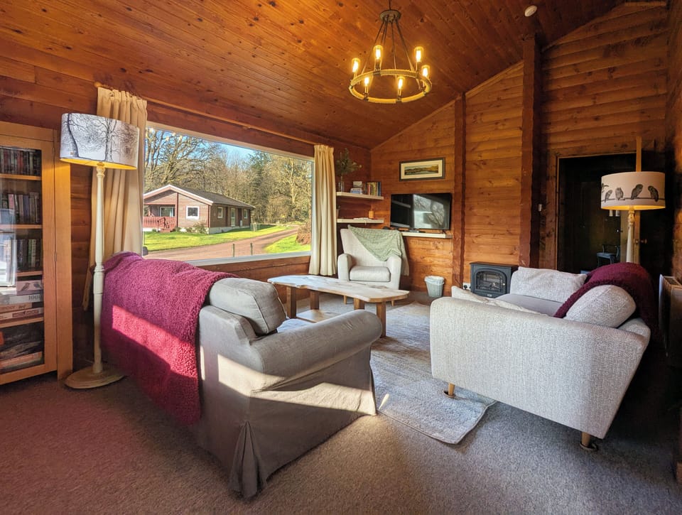 A comfy and spacious living room with large 42" TV, Blu-ray player & games