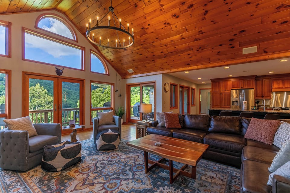 Soaring ceilings, a candle chandelier, and wall-to-wall windows framing the Blue Ridge. Gather the whole crew in this grand great room.