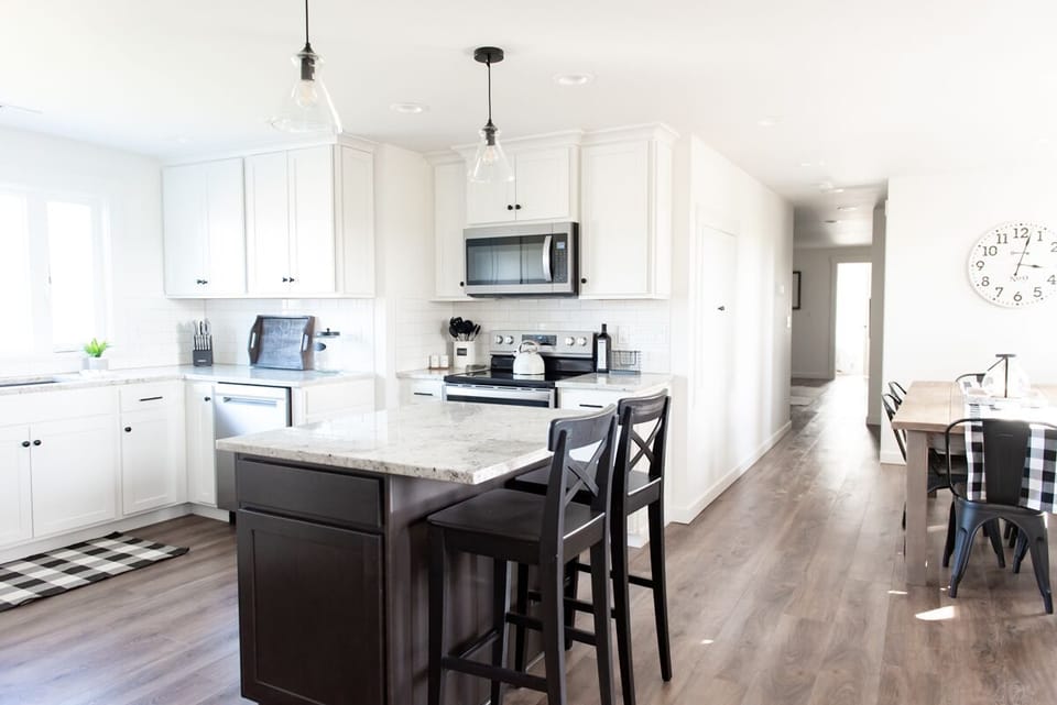 Spacious kitchen with island and large farm table.