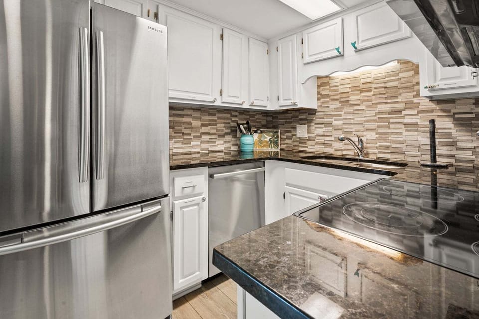 Fully equipped kitchen with a cooktop and dishwasher at Sea Lakes 103C, a Cherry Grove condo rental
