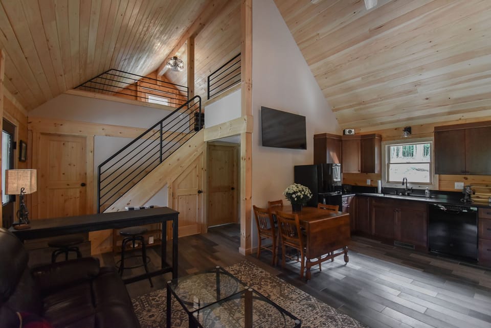 View of the kitchen as well as stairs to loft with pipe railing