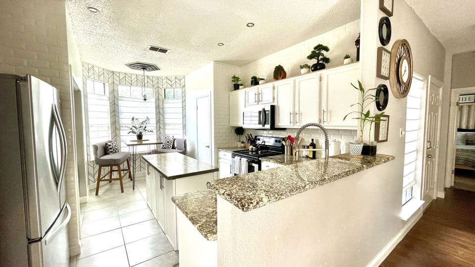 Touch-less faucet, spacious island, pantry, & coffee bar makes this kitchen fab!
