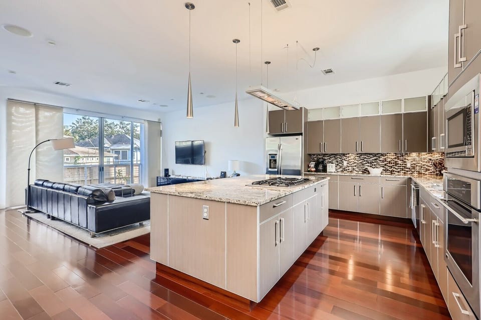 This open-concept kitchen has stainless steel appliances.