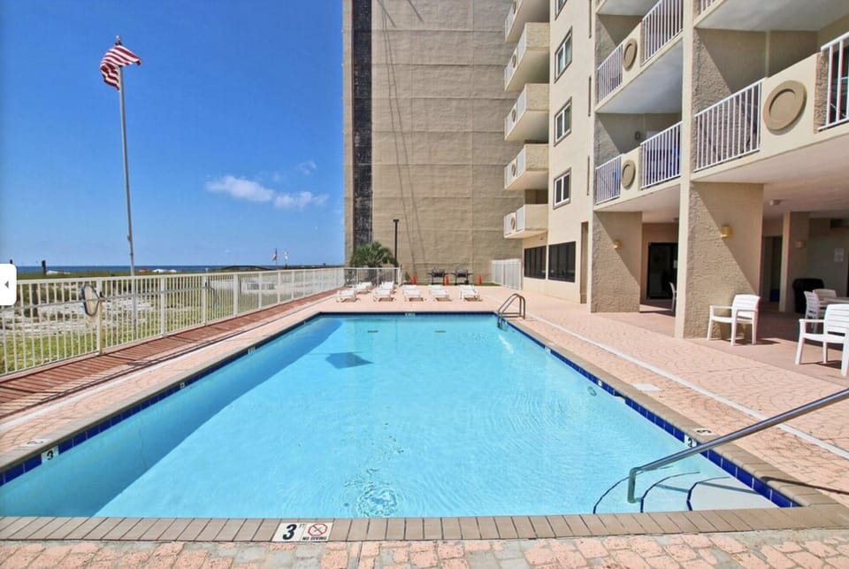 Outdoor Pool with plenty of chairs on all sides, less crowded than larger condos