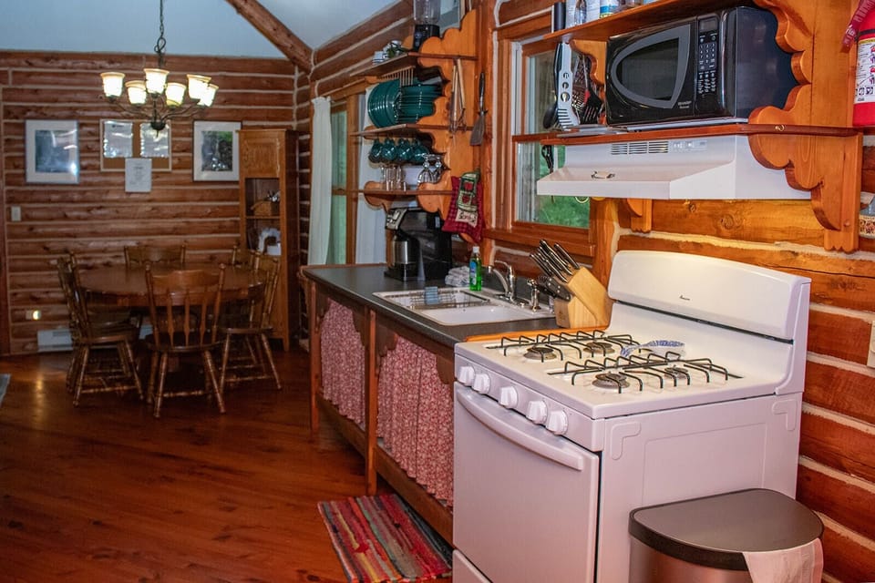 Cabin kitchen with propane stove. Microwave and everything you need.