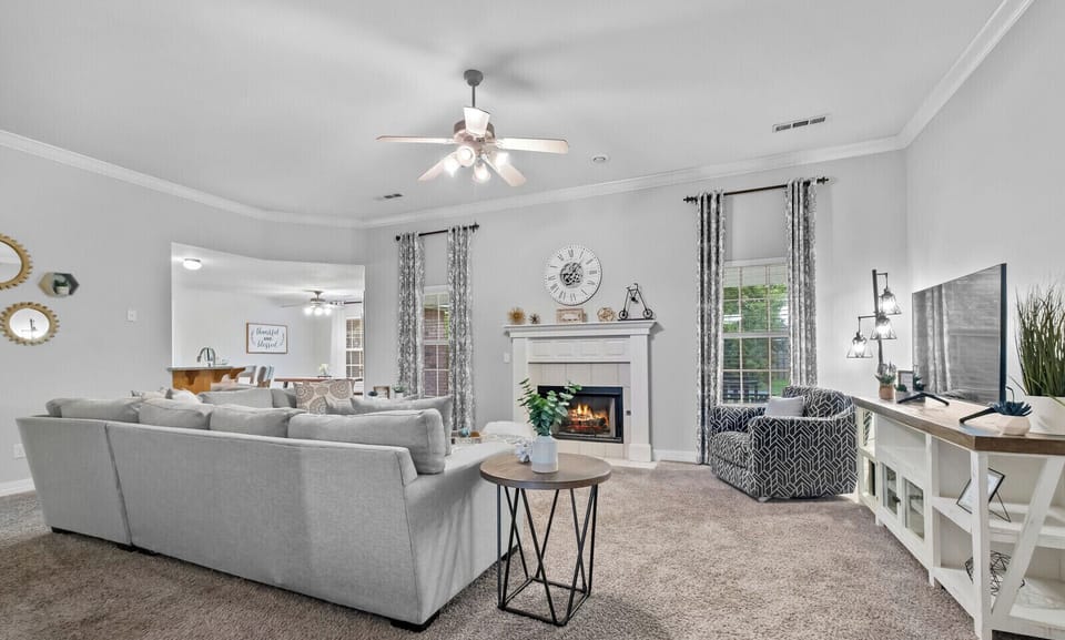 Living room with sectional, swivel chair and gas fireplace!