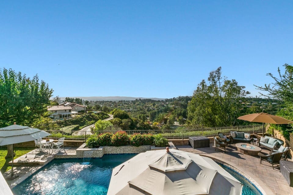 View from master bedroom balcony of pool below and sunset views